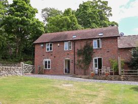 A house with a garden and seating area at Bryn Howell Stables Trevor near Llangollen
