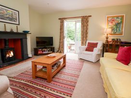 A living room with a fireplace and television at Bryn Howell Stables Trevor near Llangollen
