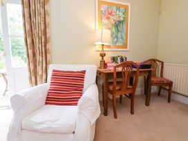 A study with an armchair and a table with chairs at Bryn Howell Stables in Trevor near Llangollen