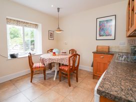 A kitchen with a table and chairs at Bryn Howell Stables Trevor near Llangollen