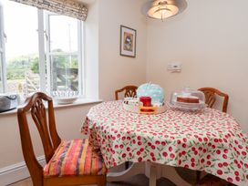 A kitchen with a table and chairs at Bryn Howell Stables Trevor near Llangollen