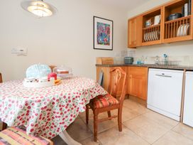 A kitchen with a dining table and chairs at Bryn Howell Stables in Trevor near Llangollen
