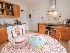 A kitchen with a dining table and chairs at Bryn Howell Stables in Trevor near Llangollen