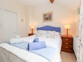 A bedroom with a double bed and bedside table at Bryn Howell Stables Trevor near Llangollen