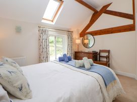 A bedroom with a bed and a dresser at Bryn Howell Stables Trevor near Llangollen