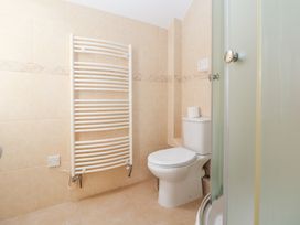 A bathroom with a toilet and towel radiator at Bryn Howell Stables in Trevor near Llangollen