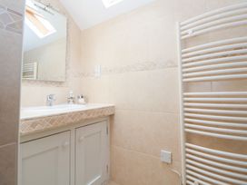 A bathroom with a sink and mirror at Bryn Howell Stables in Trevor near Llangollen