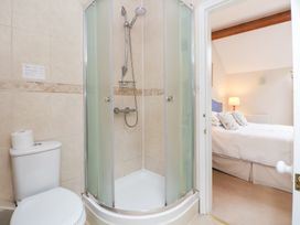 A bathroom featuring a shower and toilet at Bryn Howell Stables Trevor near Llangollen