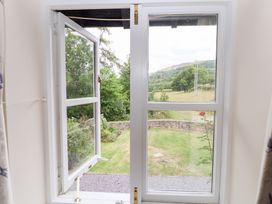 A view of a garden from a window at Bryn Howell Stables in Trevor near Llangollen