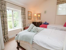 A bedroom with two beds and a view outside at Bryn Howell Stables in Trevor near Llangollen