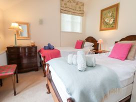 A bedroom with two beds and a dresser at Bryn Howell Stables Trevor near Llangollen