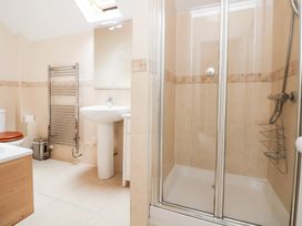 A bathroom with a shower, sink and bathtub at Bryn Howell Stables in Trevor near Llangollen