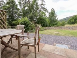 An outdoor dining area with a table and chairs at Bryn Howell Stables Trevor near Llangollen