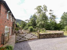 An outdoor area with a gate and table at Bryn Howell Stables Trevor near Llangollen