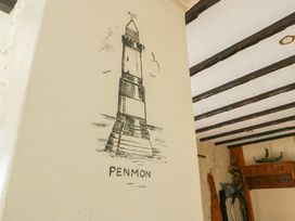 A wall with a drawing of a lighthouse labeled Penmon at Crow's Nest Cottage in Tynygongl near Benllech