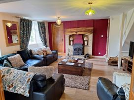 A living room with a sofa and fireplace at Boundcliffe Farm in Allerston near Pickering