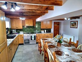 A kitchen with cabinets, dining table, and oven at Boundcliffe Farm Allerston near Pickering