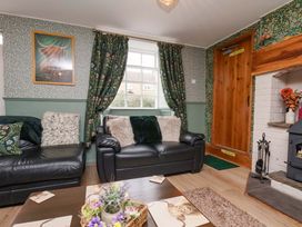 A living room with a sofa and fireplace at Boundcliffe Farm in Allerston near Pickering