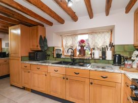A kitchen with wooden cabinets and appliances at Boundcliffe Farm in Allerston near Pickering