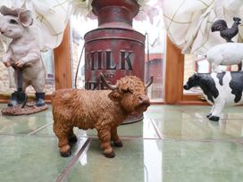 A collection of animal figurines and a milk can in a conservatory at Boundcliffe Farm Allerston near Pickering