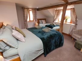 A bedroom with two beds and a window at Boundcliffe Farm Allerston near Pickering