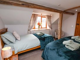 A bedroom with two beds and a window at Boundcliffe Farm in Allerston near Pickering