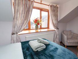 A bedroom with a bed and curtains at Boundcliffe Farm Allerston near Pickering