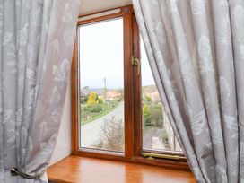 A window with curtains in a living room at Boundcliffe Farm in Allerston near Pickering