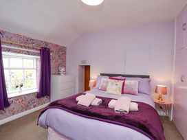 A bedroom with a bed and dresser at Boundcliffe Farm Allerston near Pickering