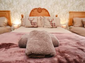 A bedroom with a bed, pillows, and towels at Boundcliffe Farm Allerston near Pickering