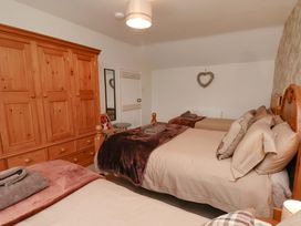 A bedroom with two beds and a wooden wardrobe at Boundcliffe Farm in Allerston near Pickering