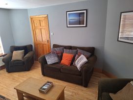 A living room with a sofa and armchairs at 19 River Glen, Curracloe, County Wexford