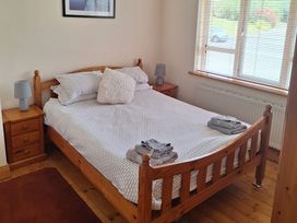 A bedroom with a bed and bedside tables at 19 River Glen in Curracloe, County Wexford