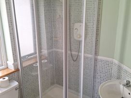A shower enclosure with a toilet and sink at 19 River Glen in Curracloe, County Wexford