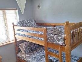 A bunk bed with bedding and towels in a bedroom at 19 River Glen Curracloe, County Wexford
