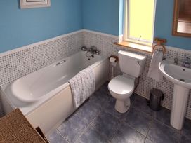 A bathroom with a bathtub, toilet, and sink at 19 River Glen, Curracloe, County Wexford