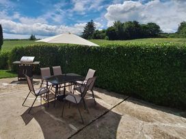 A patio with a table and chairs at 19 River Glen, Curracloe, County Wexford