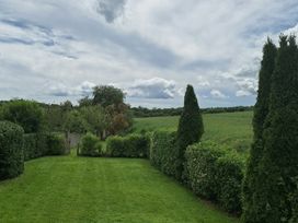A garden with grass and hedges at 19 River Glen, Curracloe, County Wexford