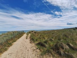 A sandy path leading to the ocean at 19 River Glen, Curracloe, County Wexford