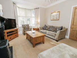 A living room with a television and coffee table at Tyddyn Goronwy in Talybont