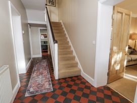 A hallway with stairs and a rug at Tyddyn Goronwy in Talybont