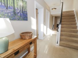 A hallway with a console table and staircase at Tyddyn Goronwy in Talybont
