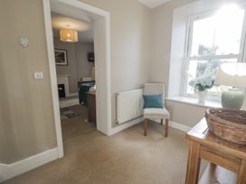 A hallway with a chair and table at Tyddyn Goronwy in Talybont