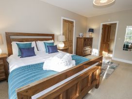 A bedroom with a bed and bedside tables at Tyddyn Goronwy in Talybont