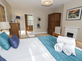 A bedroom with a bed and dresser at Tyddyn Goronwy in Talybont