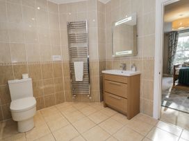 A bathroom with a sink, toilet and towel rail at Tyddyn Goronwy in Talybont