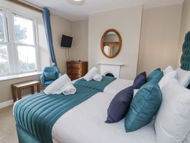 A bedroom with two beds at Tyddyn Goronwy in Talybont