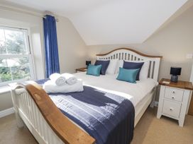 A bedroom with a bed and a bedside table at Tyddyn Goronwy in Talybont