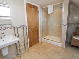 A bathroom with a shower and sink at Tyddyn Goronwy in Talybont