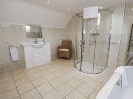 A bathroom with shower and vanity unit at Tyddyn Goronwy in Talybont
